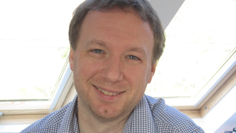 Man in shirt smiling at camera