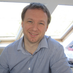 Man in shirt smiling at camera