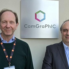 Head and shoulder image of two men in front of a sign with Camgraphic