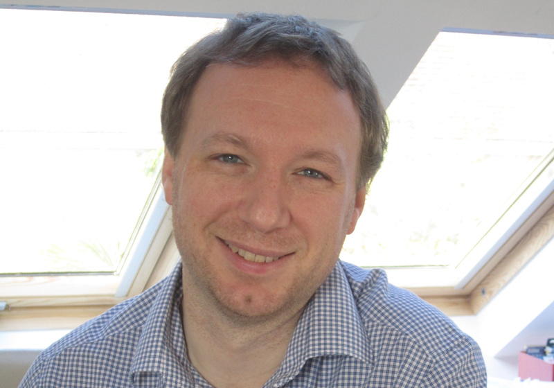 Man in shirt smiling at camera